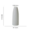 A tall, white ceramic desktop vase with an organic ripple design.