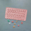 A pink silicone mold set featuring uppercase letters and numbers for baking