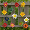 A set of metal flower wall decorations featuring various colorful, sculpted flowers hanging on a wooden fence.