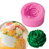 A pink silicone mold shaped like a rose flower is shown next to a decorated cake.