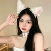A woman models a Kawaii Cat Ear Headband with Bell Choker set against a light background.