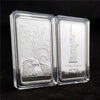 A clear acrylic display case holding a replica of a 1 Troy ounce silver bullion bar featuring an eagle and torch design.