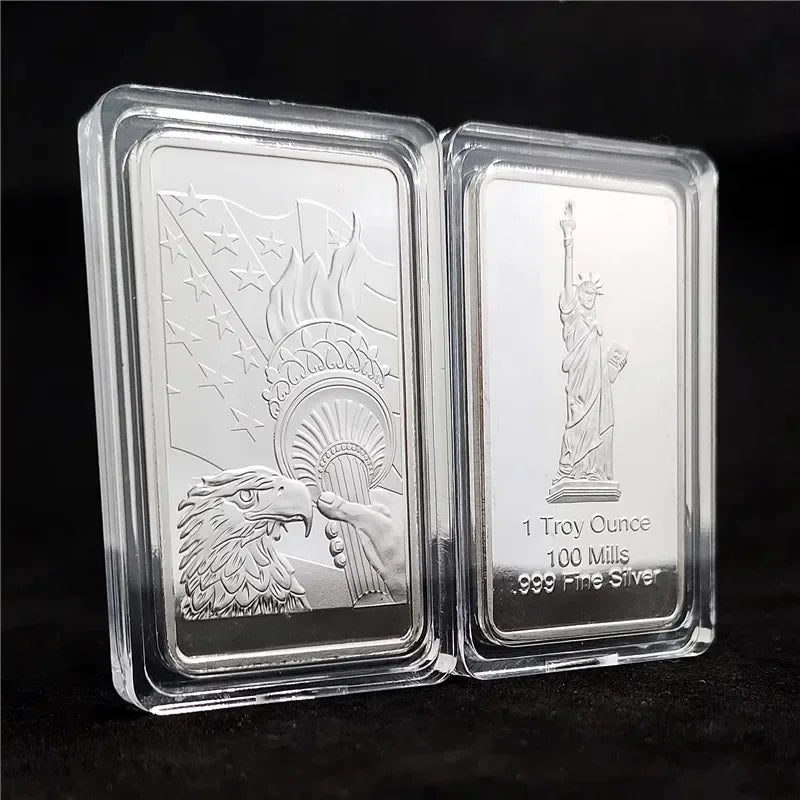 A clear acrylic display case holding a replica of a 1 Troy ounce silver bullion bar featuring an eagle and torch design.