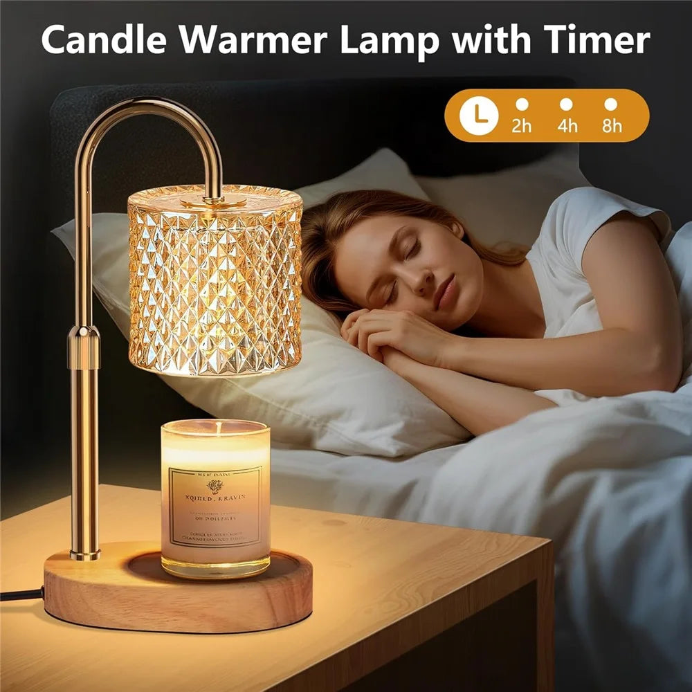 A gold-toned candle warmer lamp with a timer sits on a wooden surface next to a woman sleeping in bed.