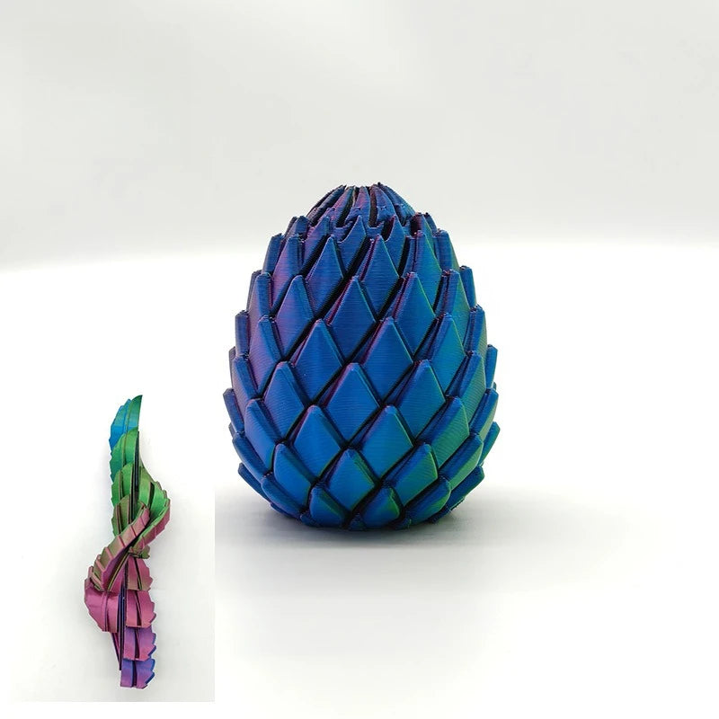 A close-up view of a blue dragon egg fidget toy with iridescent scales and a smaller version.