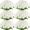A cluster of white artificial silk roses arranged as a bouquet for table decor.