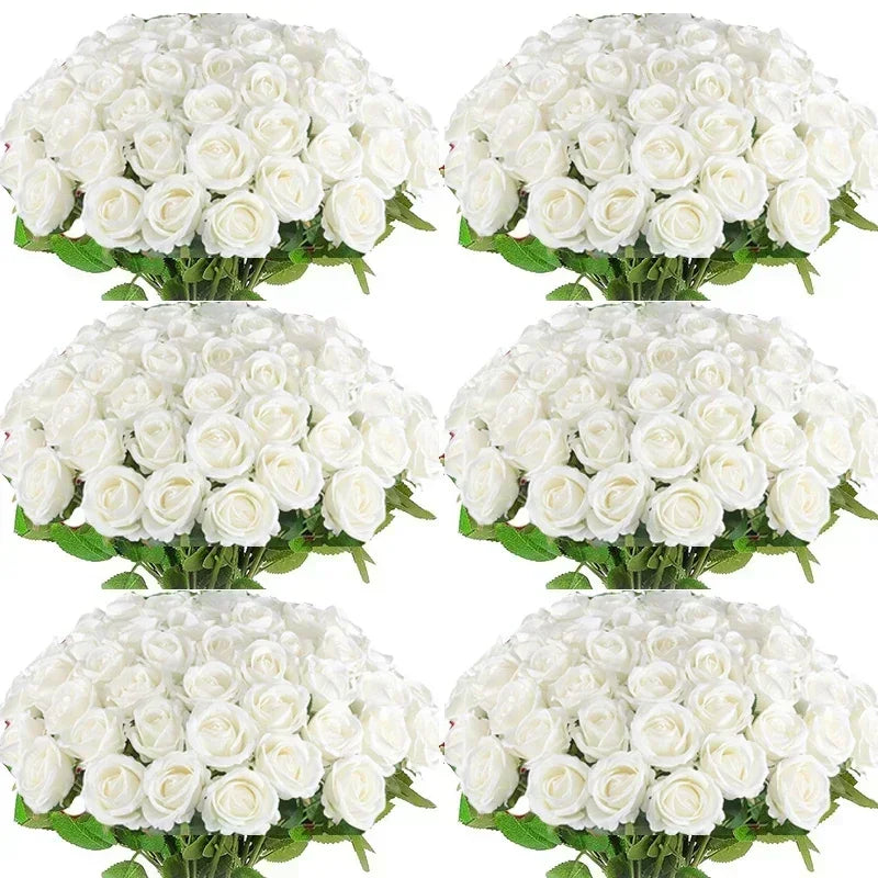 A cluster of white artificial silk roses arranged as a bouquet for table decor.