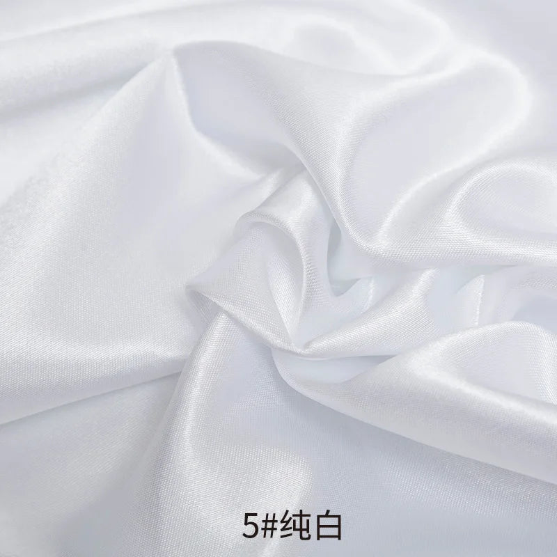 White satin fabric draped and folded for sewing or DIY projects