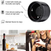 A close-up of a black reusable silicone wine bottle stopper with a rotating lock mechanism.