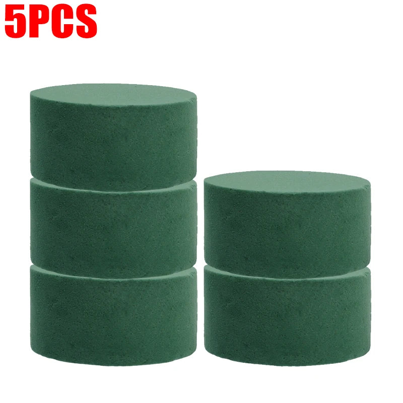 Five round blocks of green floral foam for flower arrangements
