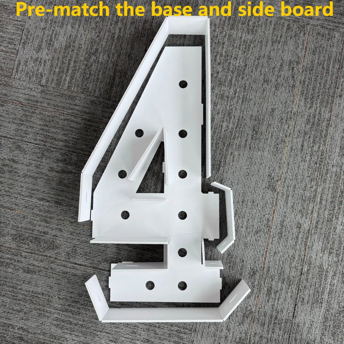 A white marquee number sign shaped like the numeral 4 is shown with its base and side board components.