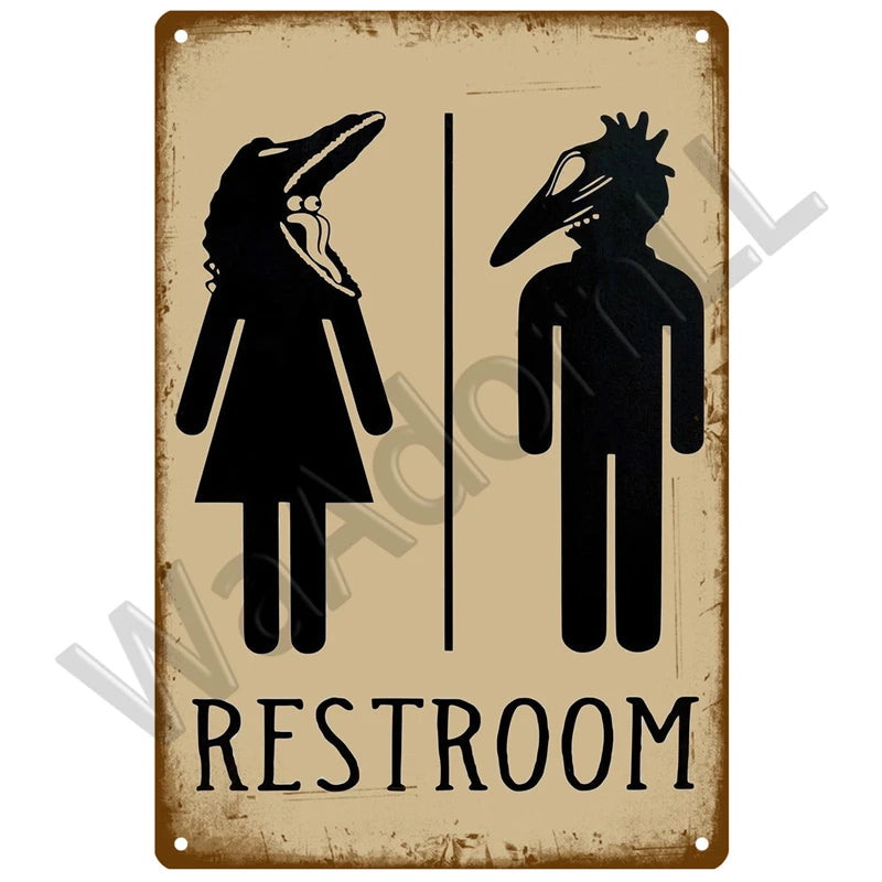 A vintage metal sign depicting silhouettes of a male and female figure for a restroom entrance.