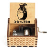 A wooden music box featuring a silhouette of Totoro on the lid and a hand-cranked mechanism inside.
