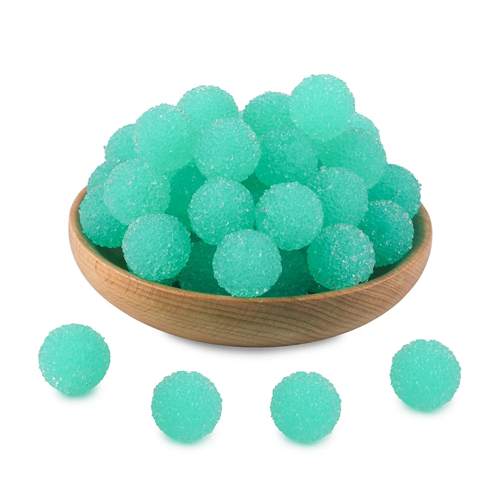 A bowl filled with a set of ten bright turquoise resin beads for jewelry making