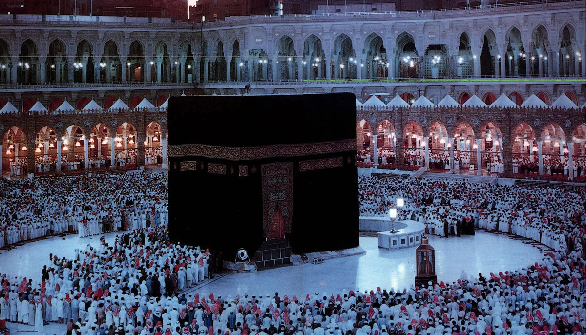A large crowd of people gathered in front of a dark canvas depicting the Kaaba and Al Masjid An Nabawi.