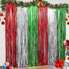 A backdrop featuring vertical metallic foil fringe curtains in red, white, and green stripes.