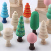 A set of colorful wooden DIY ornaments shaped like trees and spheres.