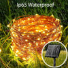 A bundle of warm yellow fairy string lights is shown outdoors in the rain, demonstrating its Ip65 waterproof protection.