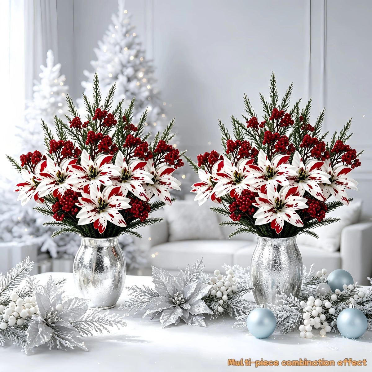 A bouquet of festive red and white artificial flowers displayed on a white table with silver accents.