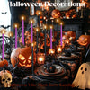 A Halloween decoration display featuring various candles and carved pumpkins on a dark table.