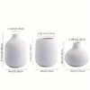 Set of three minimalist white ceramic decorative vases shown in various sizes and angles.