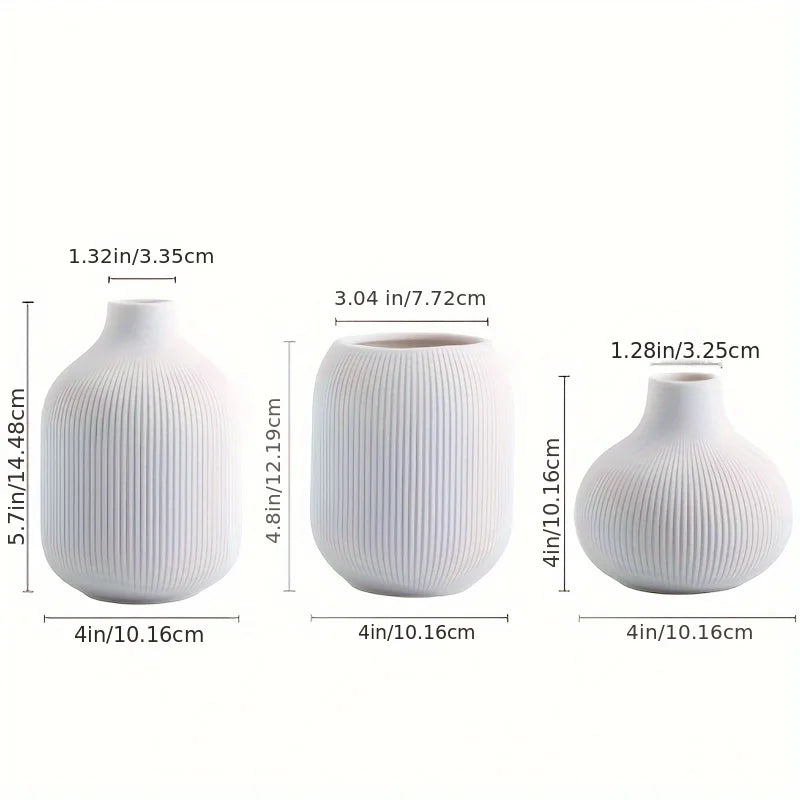 Set of three minimalist white ceramic decorative vases shown in various sizes and angles.
