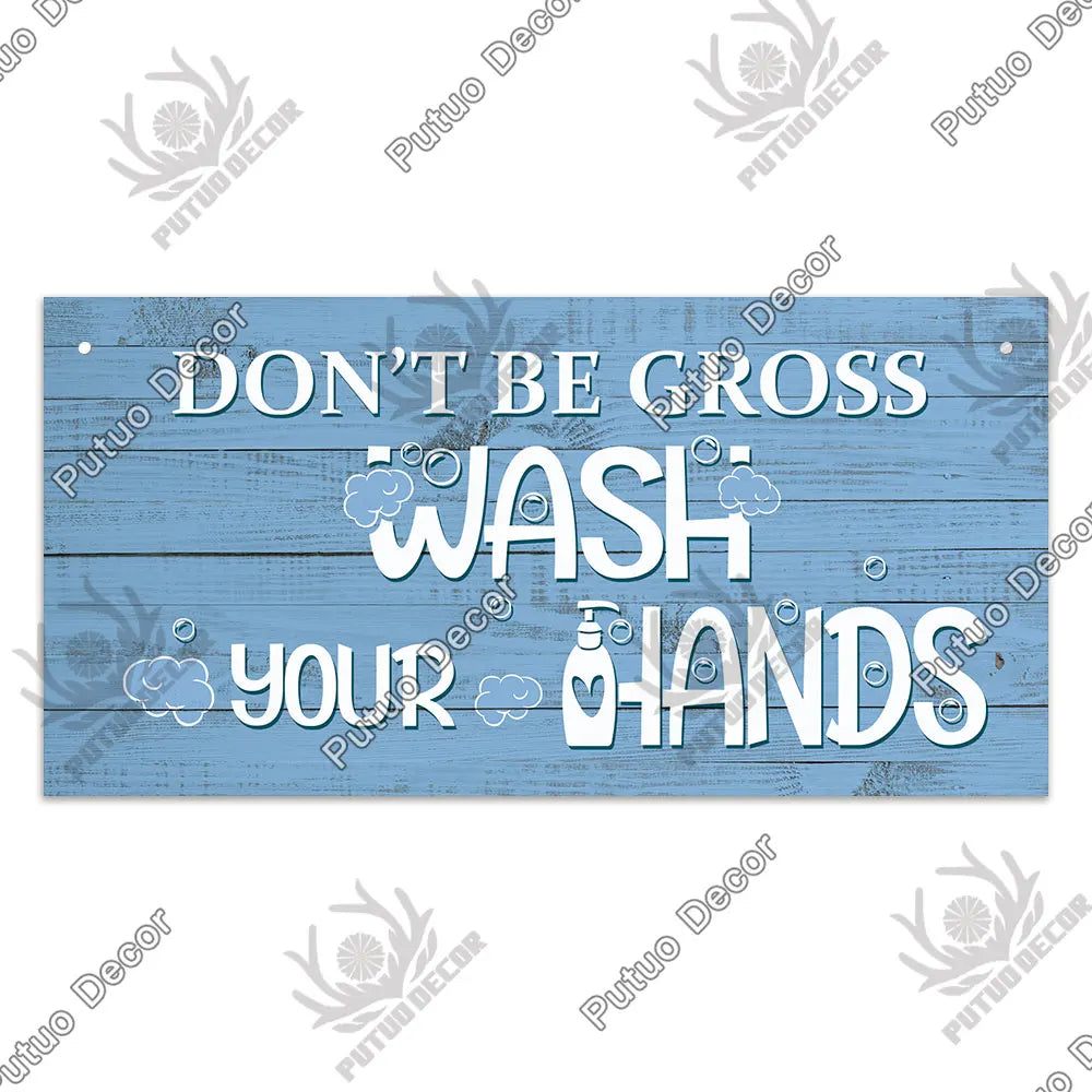 A rustic wooden sign with blue distressed paint that reads Don't be cross wash your hands