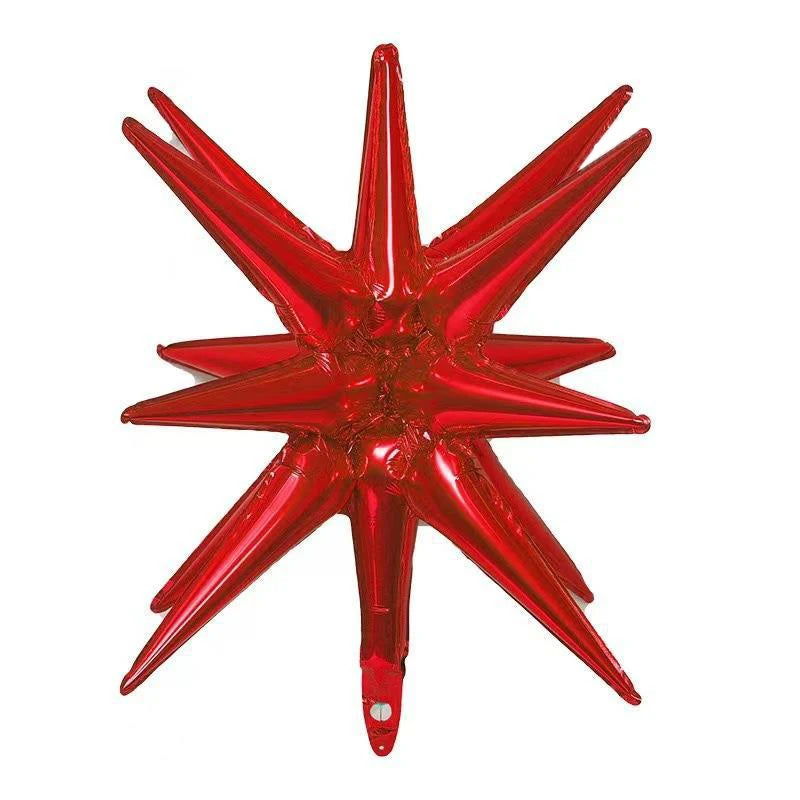 A red star burst foil balloon with sharp points, used for party decor.