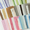 A collection of vintage old English manuscript decor paper sheets in various muted greens, browns, pinks, and blues.