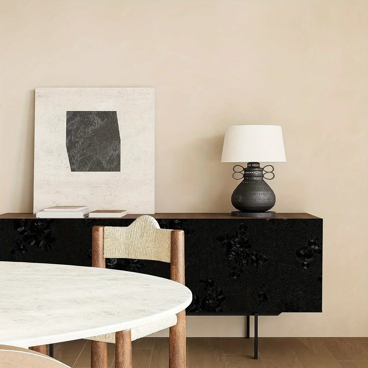 A table setting featuring a white marble tabletop, a dark wood cabinet, and a lamp with a black base.