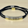 A black beaded bracelet with silver and gold metal accents engraved with the phrase God is in control