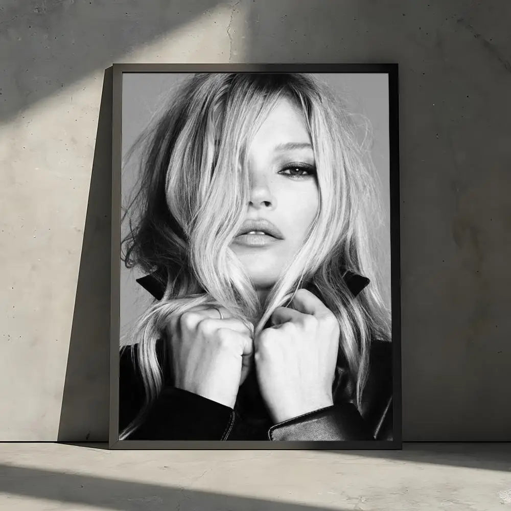 A black and white portrait of a blonde woman with tousled hair looking directly at the camera.