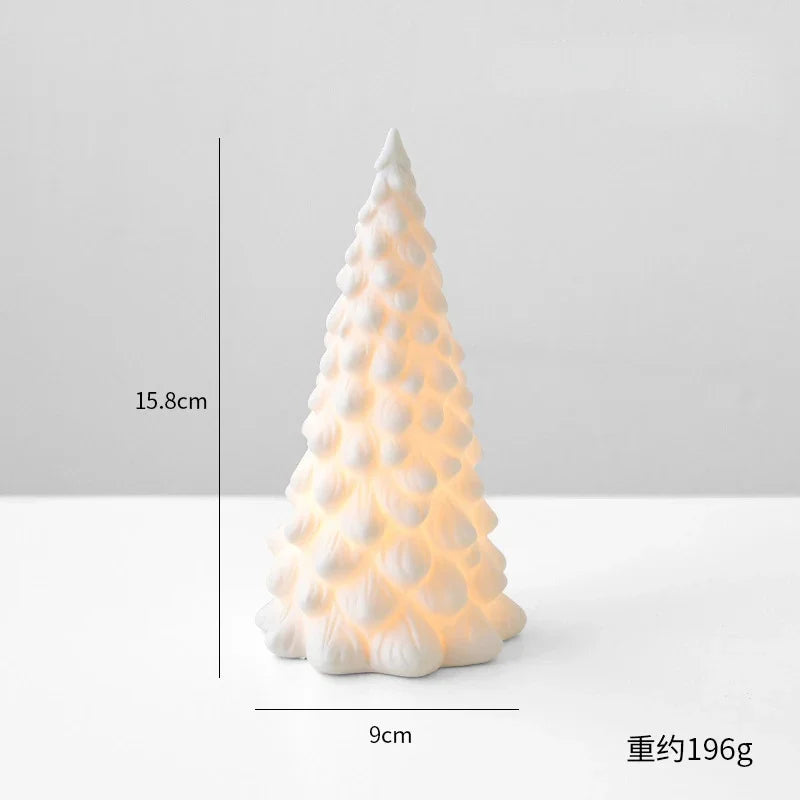 A white ceramic glow-in-the-dark mini Christmas tree decor shaped like a conical evergreen.