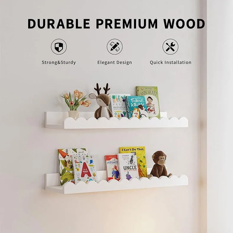 A set of two white wooden floating shelves displaying children's books and decorative items.