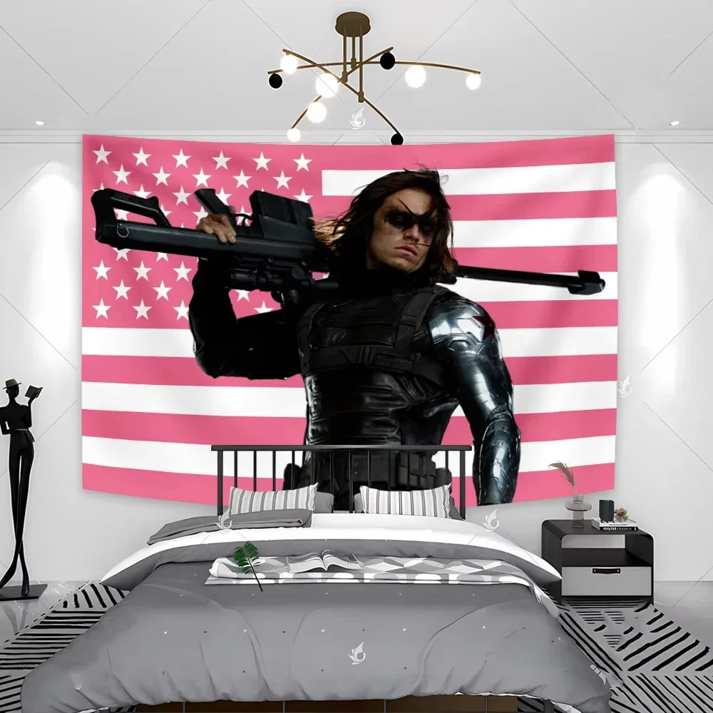 A large pink American flag tapestry wall hanging above a bed, featuring a person in black leather attire holding a rifle.