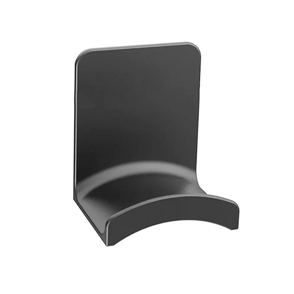 A black adhesive headphone stand designed for use on a desk or wall.