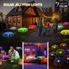Solar jellyfish lights illuminating a wooden house and garden with colorful glowing spheres.