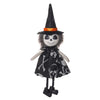 A black witch ornament featuring a pointed hat, orange trim, and a face painted like a skull.