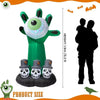 A green inflatable Halloween decoration shaped like a monster head with a large eye and built-in LED lights.