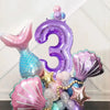 A set of purple and pink mermaid shell number balloons forming the number three for a party decoration