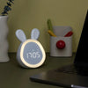 A white, rabbit-shaped LED alarm clock night light displaying 7:05 on a desk.