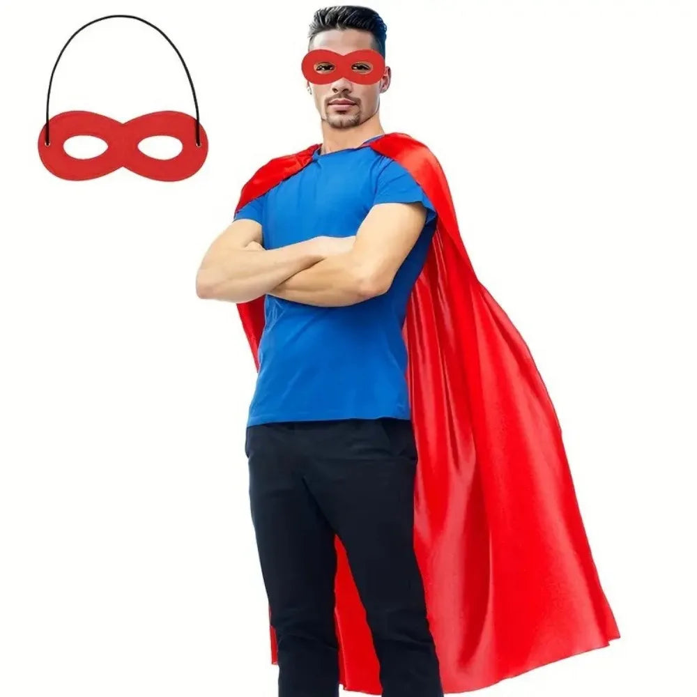 A man wearing a blue shirt and black pants with a red cape and red eye mask.