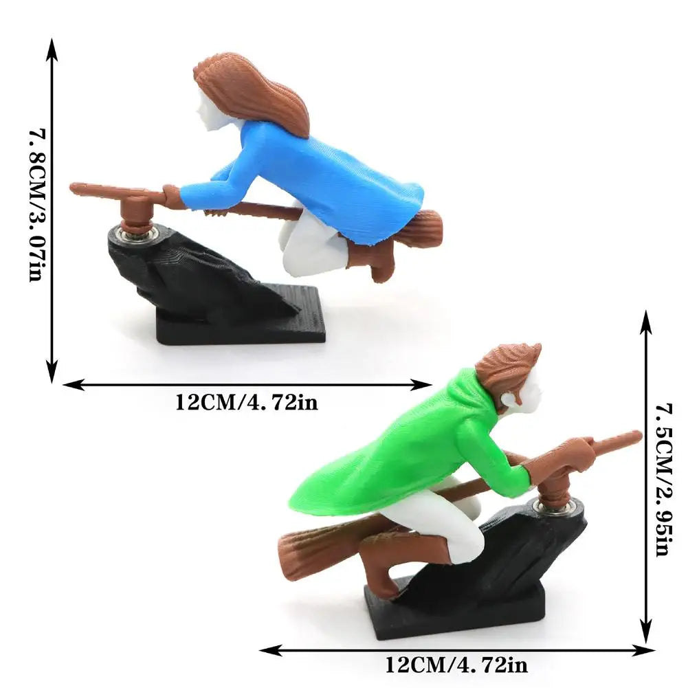 A miniature witch and wizard figure is shown with a flying carriage, demonstrating the dashboard drift decor.