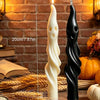 A set of black and white ghost and mummy scented soy candles displayed on a wooden surface with wheat stalks.