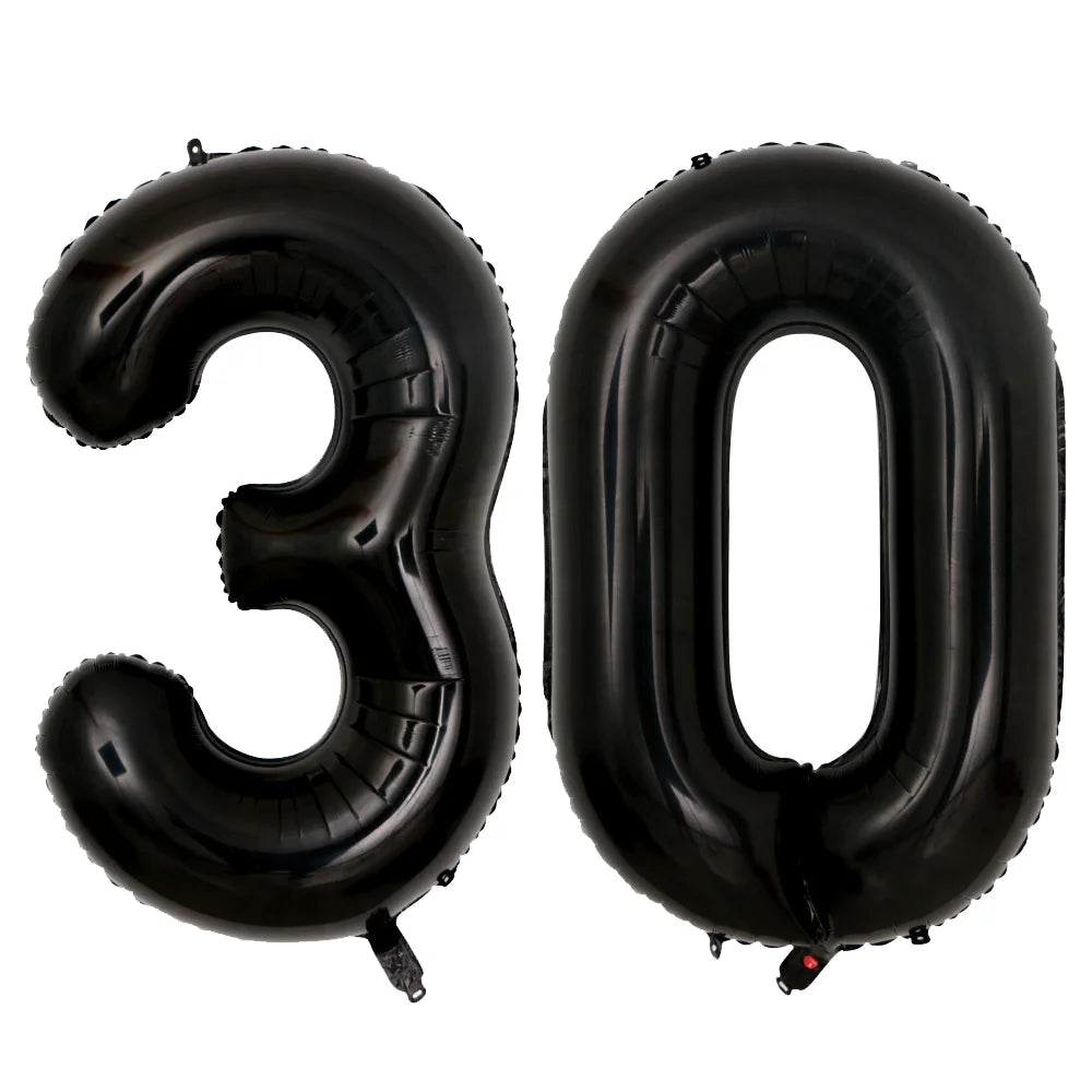 A set of two giant black foil balloons shaped like the number 30