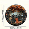 Circular wooden decor sign featuring a witch figure surrounded by autumn leaves and dark branches.