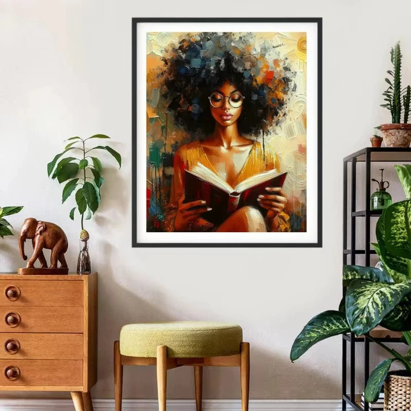 Canvas wall art featuring an African American woman with dark curly hair reading a book in warm tones.