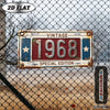 A vintage metal year wall plaque for 1968 displayed on a chain-link fence.