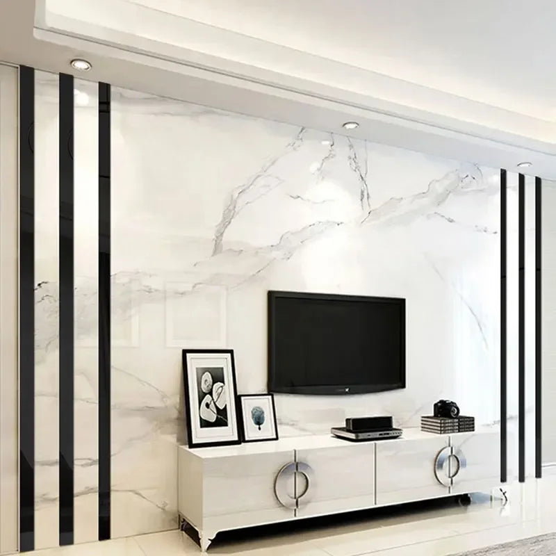 Modern home decor featuring a white marble wall with black vertical strips and a flat-screen TV above a white cabinet.