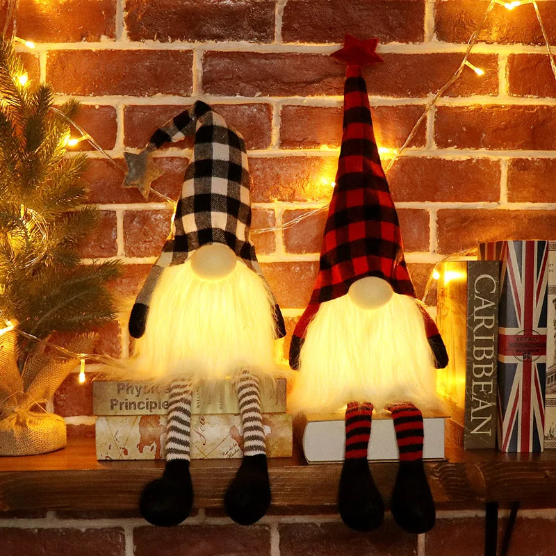 An illuminated LED gnome Christmas decoration with a plaid hat and white beard sitting on a wooden surface.